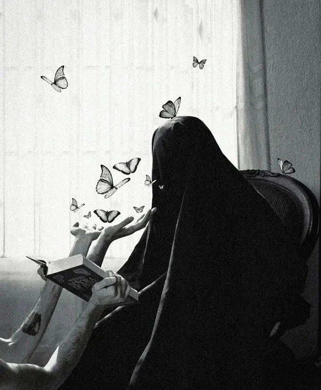 Black and white photograph of an entity covered by a robe, seated on a chair, in front of which hands hold an open book from which butterflies are emerging.