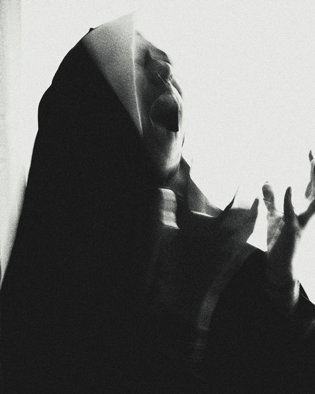 Black and white photograph nun screaming in despair.