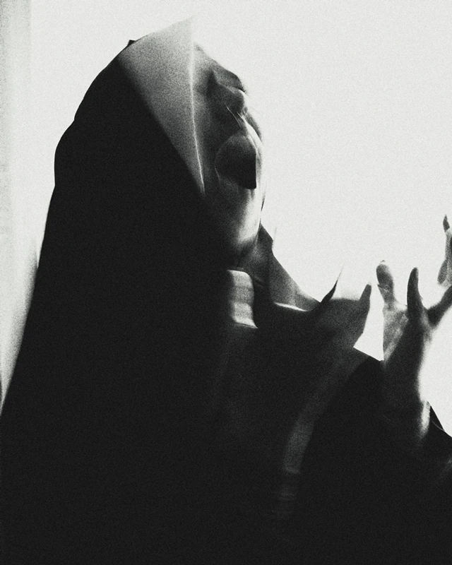 Black and white photograph nun screaming in despair.